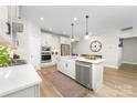 Modern kitchen with white countertops, stainless steel appliances, and an island with a sink and dishwasher at 12636 Twilight Dr, Mint Hill, NC 28227