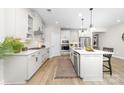 Bright kitchen featuring white cabinets, stainless steel appliances, a large island, and hardwood floors at 12636 Twilight Dr, Mint Hill, NC 28227