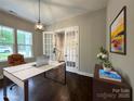 Bright home office with French doors, wood floors, modern lighting and a neutral color palette at 157 Powder Spring Dr, Statesville, NC 28677