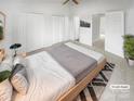 Spacious, staged main bedroom featuring three closets, neutral colors and ceiling fan at 16837 Greenlawn Hills Ct, Charlotte, NC 28213