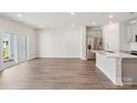 Bright, open-concept living room features stainless steel appliances and patio access at 1733 Braemar Village Dr, Monroe, NC 28110