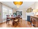 Elegant dining room featuring hardwood floors, fireplace, and decorative ceiling at 239 Euclid Ave, Statesville, NC 28677