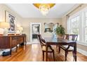 An open dining room with hardwood floors, chandelier, and natural light creates an elegant gathering space at 239 Euclid Ave, Statesville, NC 28677