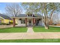 Charming single-Gathering home with a welcoming front porch and well-manicured lawn at 239 Euclid Ave, Statesville, NC 28677