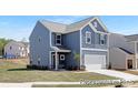 Beautiful new construction home with blue siding, white trim, and a two-car garage, located in a Gathering-friendly community at 265 Red Fox Ln # 1P, China Grove, NC 28023