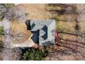 Aerial view of a well-maintained home featuring a deck, driveway, and mature trees at 304 Keller St, China Grove, NC 28023