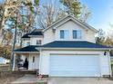 Charming two-story home with a two-car garage and cozy front porch with swing at 312 Radio Rd, Charlotte, NC 28216