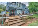 Inviting back deck features brick stairs, outdoor seating, and access to the home's interior at 405 Northwest Dr, Davidson, NC 28036