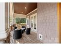 Cozy covered porch with comfortable seating, perfect for relaxation and enjoying the outdoors at 4915 Ardenwoods Dr, Charlotte, NC 28215