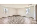 Bright living room featuring wood-look flooring and natural light from two windows at 5336 Small St, Catawba, NC 28609