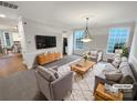 Cozy living room features neutral tones, natural light, and comfortable seating at 6409 Chadwell Ct, Fort Mill, SC 29707