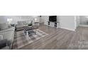 Comfortable living room showcasing wood-look flooring, cozy seating, and natural light at 730 Bonica Ct, Lancaster, SC 29720