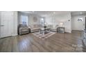 Bright living room featuring hardwood floors, neutral decor, and an open layout at 730 Bonica Ct, Lancaster, SC 29720