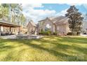 Spacious backyard featuring a patio with a firepit and covered outdoor seating area at 7674 Bermuda Hills Ln, Denver, NC 28037