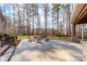 Stone patio with an outdoor firepit and wooded views at 7674 Bermuda Hills Ln, Denver, NC 28037