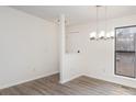 Bright dining room featuring modern chandelier and updated flooring at 8104 Tamalpais Ct, Charlotte, NC 28215