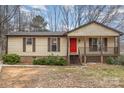 Charming single-story home features a cozy front porch and a bright red front door at 8104 Tamalpais Ct, Charlotte, NC 28215
