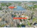 An aerial view of a brick home in a wooded neighborhood with lake access at 907 Thorn Ridge Ln, Lake Wylie, SC 29710