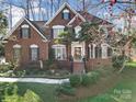 Beautiful brick home featuring classic architecture and lush landscaping at 907 Thorn Ridge Ln, Lake Wylie, SC 29710