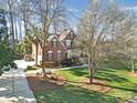 An eye-level side view of a brick home with a well-maintained lawn and curb appeal at 907 Thorn Ridge Ln, Lake Wylie, SC 29710