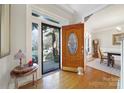 Inviting foyer with a decorative wood door and views into the dining room at 907 Thorn Ridge Ln, Lake Wylie, SC 29710