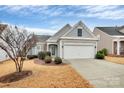 Charming home featuring a two-car garage, stone accents, and a beautifully landscaped front yard at 9119 Gander Dr, Charlotte, NC 28277