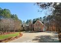 Beautiful brick home with a circular driveway and a well-maintained lawn at 9135 Fair Oak Dr, Sherrills Ford, NC 28673