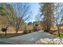 Long, private driveway leads to a beautiful brick home surrounded by mature trees at 9135 Fair Oak Dr, Sherrills Ford, NC 28673