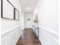 Inviting entryway with a console table, hardwood floors, and bright, neutral walls at 103 Noah Ln, Troutman, NC 28166