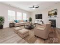Bright living room features hardwood floors, a fireplace, comfortable seating, and ample natural light at 10335 Rutledge Ridge Nw Dr, Huntersville, NC 28078