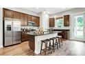 Well-equipped kitchen with a central island, stainless steel refrigerator, and stylish bar stool seating at 1043 Rabbit Hill Ln, Monroe, NC 28110