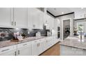 Modern kitchen features white cabinets, granite countertops, stainless steel appliances, and dark backsplash at 1047 Rabbit Hill Ln, Monroe, NC 28110