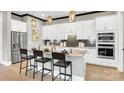 Beautiful kitchen with an island, granite countertops, stainless steel appliances, and modern pendant lights at 1047 Rabbit Hill Ln, Monroe, NC 28110