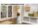 Cozy entryway featuring a bench with storage and a view into the living spaces through french doors at 105 Noah Ln, Troutman, NC 28166