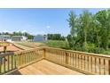 Wooden back deck shows a neighborhood, trees, and clear blue skies at 111 Rustling Waters Dr, Mooresville, NC 28117