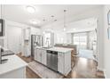 Open-concept kitchen featuring a central island with seating and stainless steel appliances with an open view to the living area at 112 Buoy Ln, Statesville, NC 28677