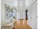 Bright foyer with high ceilings, hardwood floors, and modern decor elements on display at 1126 Snowbird Ln, Waxhaw, NC 28173