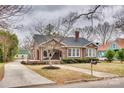 Lovely single-story brick home featuring a mature landscaped yard with a long driveway at 119 Hemphill Ave, Chester, SC 29706