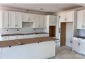 Bright, spacious kitchen featuring white cabinets and an island, prepped for modern appliances at 13248 Chopin Ridge Rd, Huntersville, NC 28078