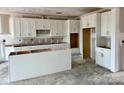 Spacious kitchen featuring white cabinetry, an island, and ample counter space, ready for customization at 13248 Chopin Ridge Rd, Huntersville, NC 28078