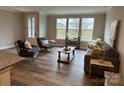 Spacious living room with large windows offering ample natural light and backyard views at 143 Carriage Club Dr # 102, Mooresville, NC 28117