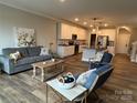 Open-concept living room and kitchen featuring sleek countertops and stainless steel appliances at 143 Carriage Club Dr # 102, Mooresville, NC 28117