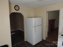 A view of the kitchen with a white refrigerator and laminate flooring at 146 Loomis St, Chester, SC 29706