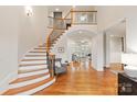 Stunning foyer features a staircase with wooden rails, hardwood floors, and an open layout at 1506 Venetian Way Dr, Waxhaw, NC 28173