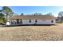 Charming single-story home features a well-maintained lawn and inviting front porch with seating at 1511 Liberty Ave, Albemarle, NC 28001