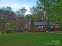 Charming brick ranch-style home with a well-maintained lawn and beautiful landscaping at 1552 10Th Street Nw Pl, Hickory, NC 28601