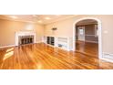 Open-concept living room featuring a fireplace, built-in shelving and hardwood floors at 1552 10Th Street Nw Pl, Hickory, NC 28601