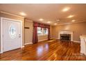 Bright living room featuring hardwood floors, fireplace, ceiling fan, and natural light at 1552 10Th Street Nw Pl, Hickory, NC 28601