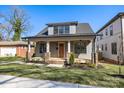 Charming home featuring a cozy front porch and well-manicured lawn at 1824 Haines St, Charlotte, NC 28216