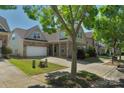 View of a home with neutral siding, brick accents, and a driveway leading to a garage at 3009 Scottcrest Way, Waxhaw, NC 28173